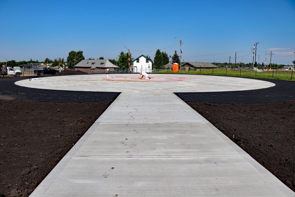 A contract worker paints the new pad of the long-awaited heliport upgrade project. Town senior staff say the project is nearly complete and could be operational by the end of September. Johnnie Bachusky/MVP Staff