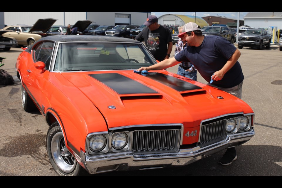 Paul Poland, foreground and Neil Morrow put the finishing touches on a 1970 Olds 442 during the 31st annual Oldsmobile Show, presented by the Northern Lights chapter of the Oldsmobile Club of America.  
Doug Collie/MVP Staff