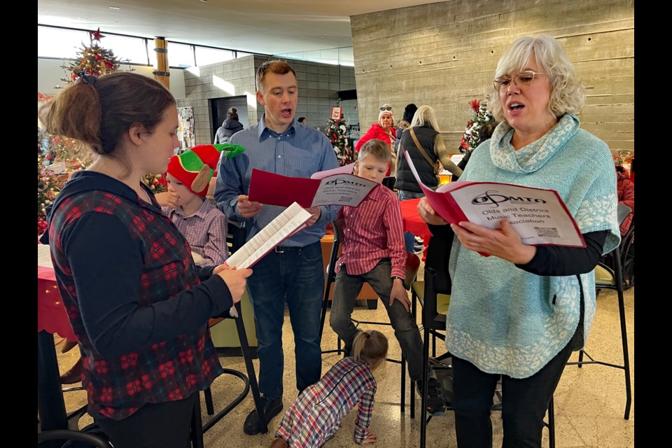 After delighting the Hometown Christmas crowds at the Innisfail Royal Canadian Legion Branch #104 earlier in the day on Dec. 2, carollers from the Olds and District Music Teachers Association sang at the Innisfail Festival of Trees at the Innisfail Library/Learning Centre. Johnnie Bachusky/MVP Staff