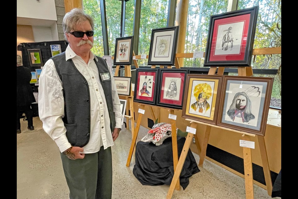 Innisfail artist Barrie Heistad with his display of fine art at the Innisfail Art Club's 7th annual Fine Art & Craft Show + Sale on Sept. 22 at the Innisfail Library/Learning Centre. Heistad was one of the club's 15 new members participating in the show. Johnnie Bachusky/MVP Staff
