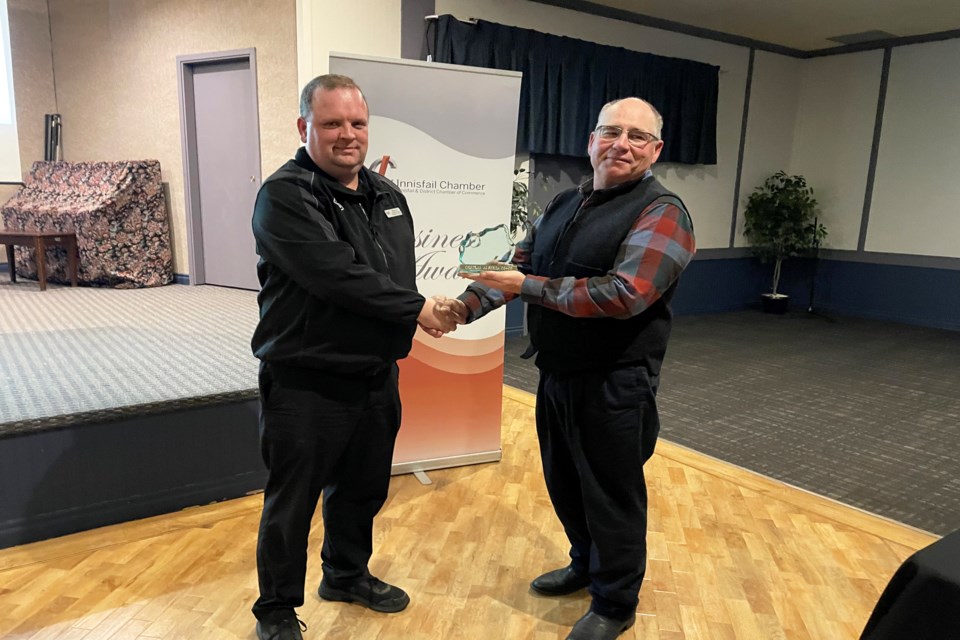 Chris Irvine, assistant food manager at Innisfail's Central Alberta Co-Op, accepts the Business of the Year Award from Blaine Staples, president of the Innisfail & District Chamber of Commerce, at the annual Innisfail business awards on Nov. 23. Johnnie Bachusky/MVP Staff