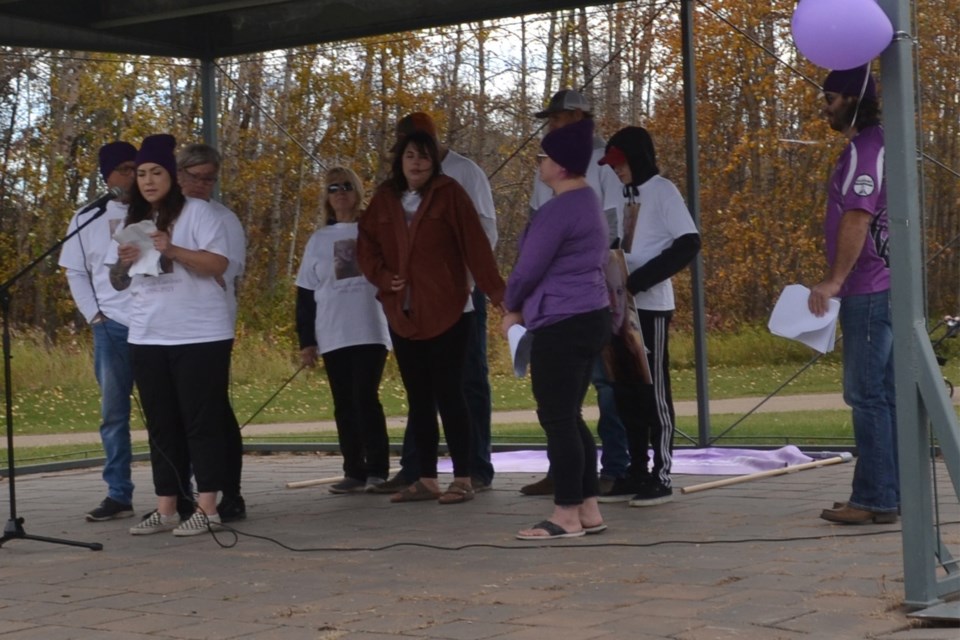 Ashley Christoffersen speaks into the microphone, telling those gathered about her sister, Kirsten Gardner, who was murdered earlier this spring. She is flanked by family members and MCs Tyrel Robinson and Erika Fetterly.
Lea Smaldon/MVP Staff