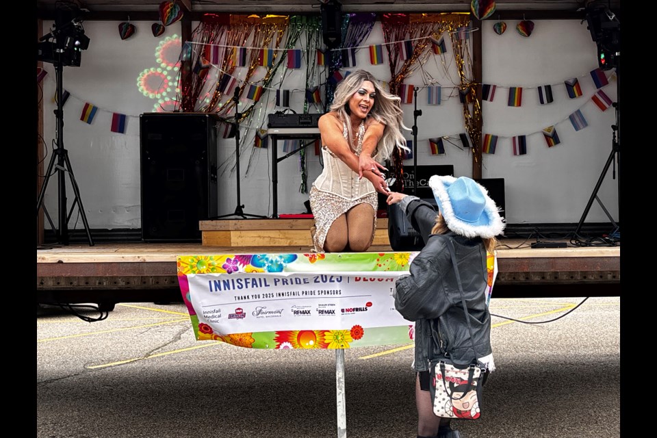 Drag dancer Berry Wet Latina receives a gift from an appreciative attendee at the 5th annual Innisfail Pride on June 21. Johnnie Bachusky/MVP Staff