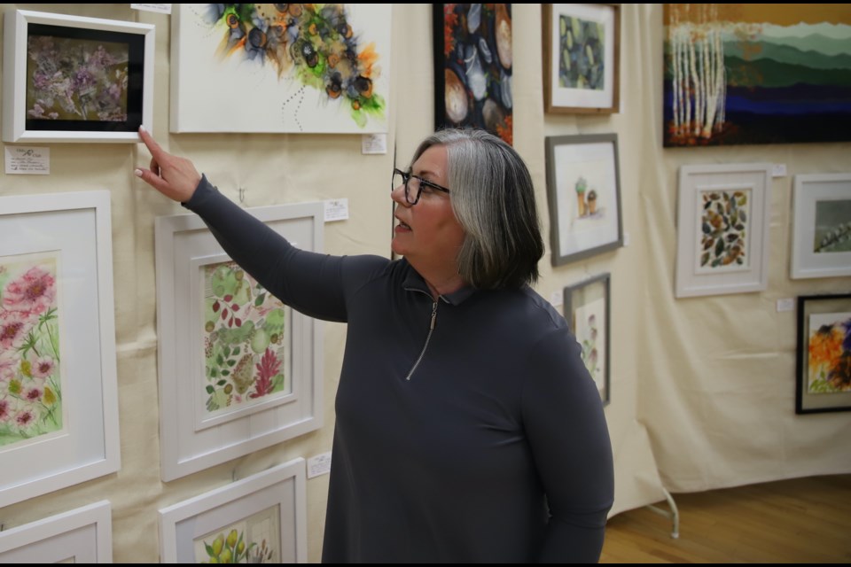 Jan Thompson, the featured artist at the Olds Art Club spring show and sale, discusses some of the features of a collage she created using bee wax as one of the ingredients. 