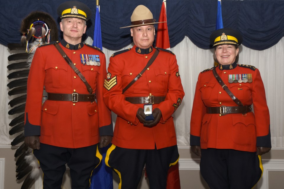 Sgt. Joe Mandel, centre, formerly a corporal at the Sundre RCMP department, was recently recognized for bravery in the call of duty over a dangerous pursuit dating back to October 2017. 
Photo courtesy of Alberta RCMP 