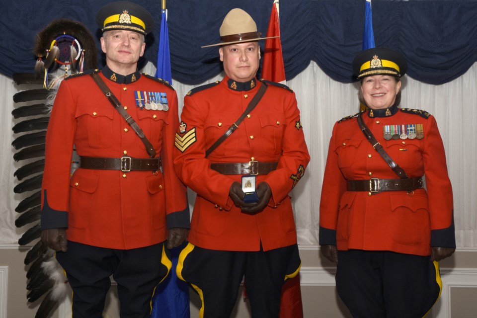 Sgt. Joe Mandel, centre, formerly a corporal at the Sundre RCMP department, was recently recognized for bravery in the call of duty over a dangerous pursuit dating back to October 2017. 
Photo courtesy of Alberta RCMP 