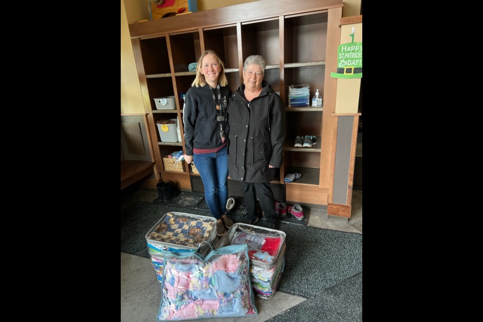 Olds resident Joyce Quaife, right, poses with RMHC Alberta program coordinator Reyanne Spina after dropping off 21 of her quilts and half a dozen made by a fellow IODE member. 