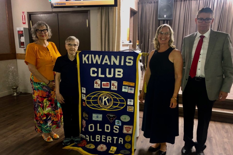 Olds mayor Judy Dahl, Kiwanis Division 7 Lieutenant Governor Rose Ward, Olds club president Annelise Doolaege, and former president Murray Elliott pose for a photo at the 70th anniversary celebration.