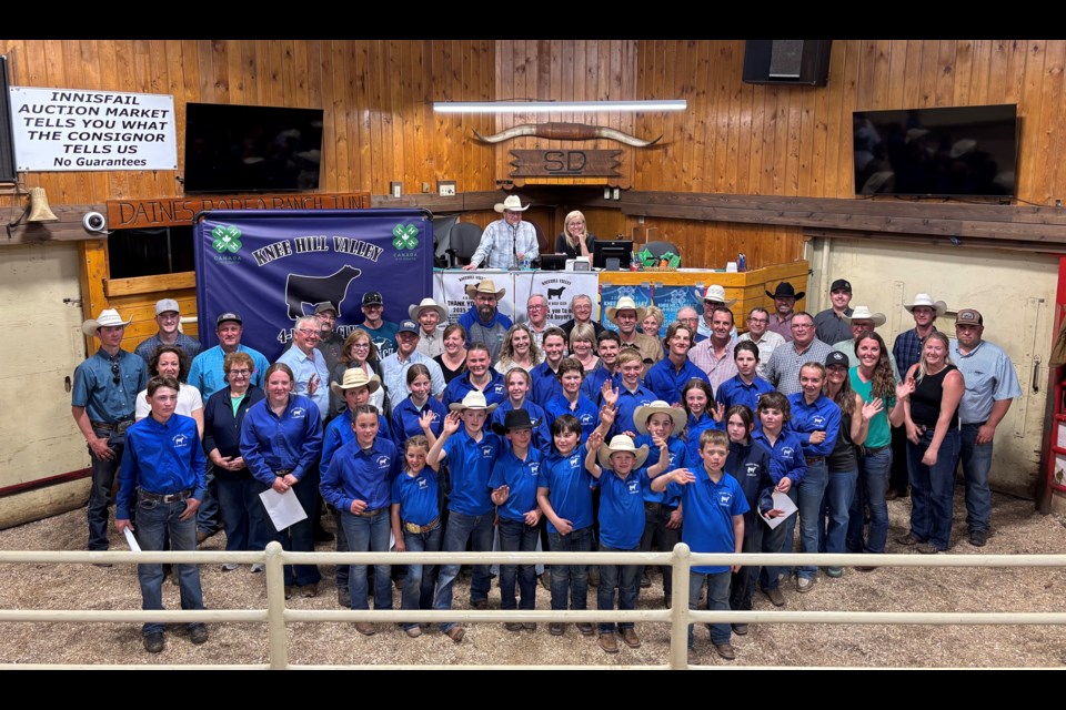 The Knee Hill Valley 4-H Beef Club Alumni, both past and present members and leaders, gather for a group photo during the 75th anniversary celebration on May 26 at the Innisfail Auction Mart. Johnnie Bachusky/MVP Staff