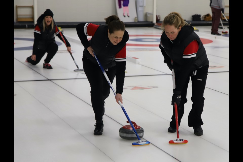 Claire Rosehill yells encouragement as teammates Colleen Braithwaite , left, and Jennifer Wood sweep during the Olds Ladies Bonspiel, held March 3-5 at the Olds Curling Club.