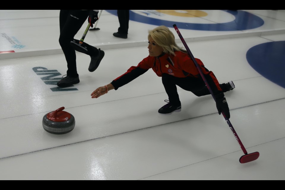 Joyce Koch throws a rock during the Olds Ladies Bonspiel.