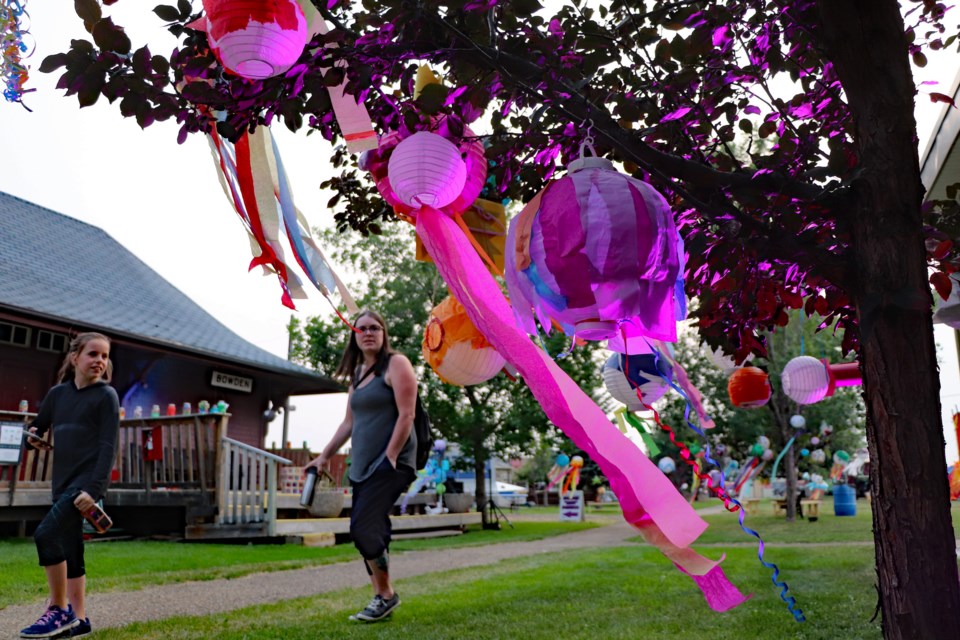 Lanterns on a tree begin to glow in the early evening during last year's inaugural Innisfail Lantern Festival. The big party for the second annual celebration is being held this year on July 16 at Centennial Park. File Photo/MVP Staff