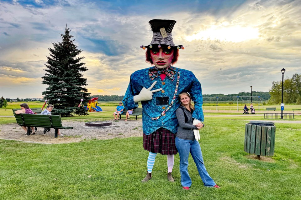 Innisfailian Amy-Lee Walker welcomes the opportunity to lean against The Mad Hatter at the Innisfail Lantern Festival that was held at Centennial Park on Aug. 20.  This year's theme for the event was Through the Looking Glass, inspired by Lewis Carroll's classic works of Alice in Wonderland. Johnnie Bachusky/MVP Staff