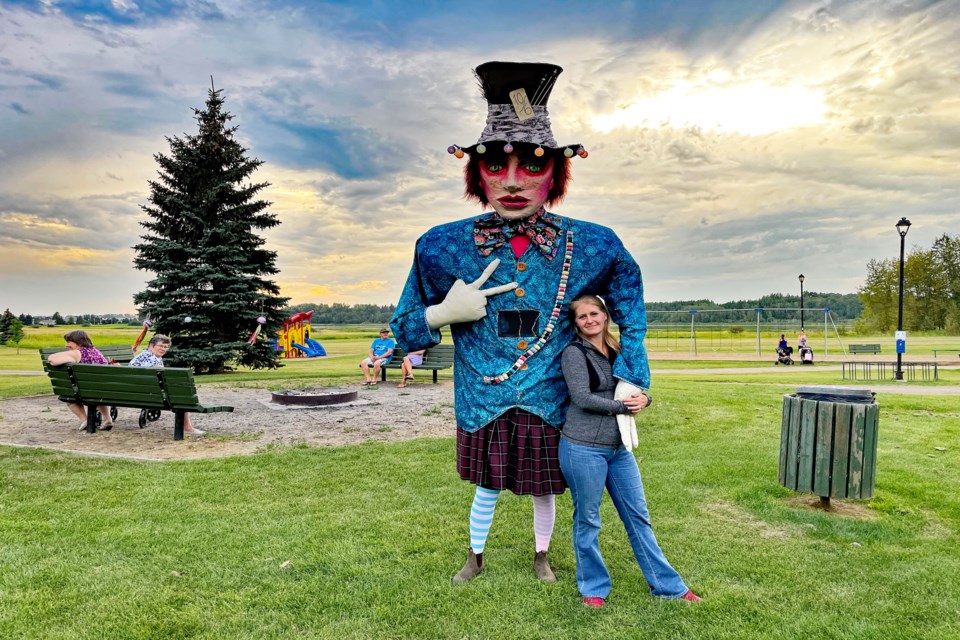 Innisfailian Amy-Lee Walker welcomes the opportunity to lean against The Mad Hatter at the Innisfail Lantern Festival that was held at Centennial Park on Aug. 20.  This year's theme for the event was Through the Looking Glass, inspired by Lewis Carroll's classic works of Alice in Wonderland. Johnnie Bachusky/MVP Staff