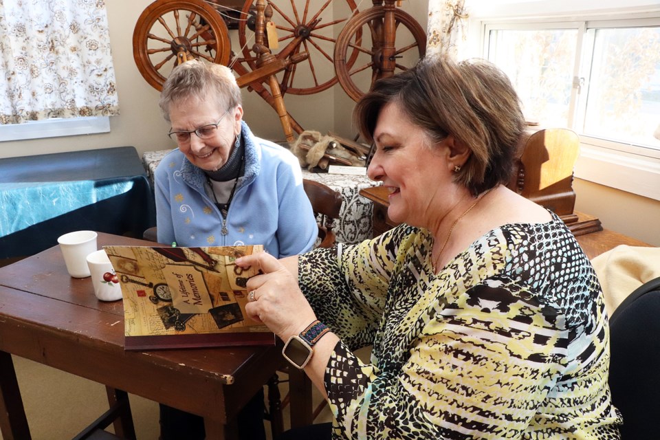 Karen Bishop, a local senior participating in the Innisfail Generations Legacy Project, left, shares a light moment with volunteer Doris Kibermanis. Johnnie Bachusky/MVP Staff