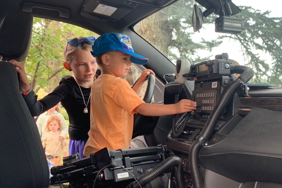 Sundre residents Hunter Blackhurst and his sister Rebecca were among more than a dozen children accompanied by their parents who on Wednesday, Aug. 20 embarked on a field trip to the Sundre RCMP detachment that was organized as part of the Sundre Municipal Library’s Summer Reading Club and included a chance to sit in a squad car driver’s seat activating emergency lights and sirens.  
Simon Ducatel/MVP Staff