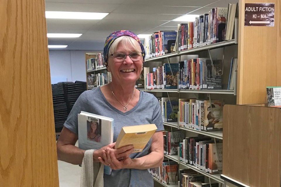 Linda Kirillo was all smiles as she loaded up a few books on Tuesday, June 23, when the Sundre Municipal Library officially reopened to the public.
Photo courtesy of Karen Tubb