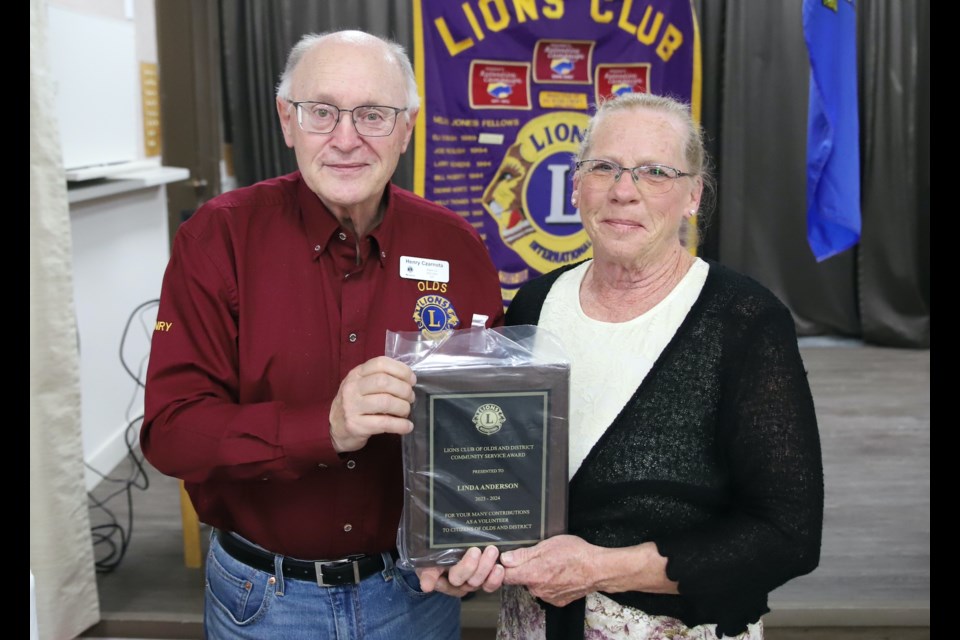 Local community volunteer and longtime member of the Royal Canadian Legion Branch #105 Linda Anderson, right, receives the first-ever Olds Lions Club District Community Service award. 