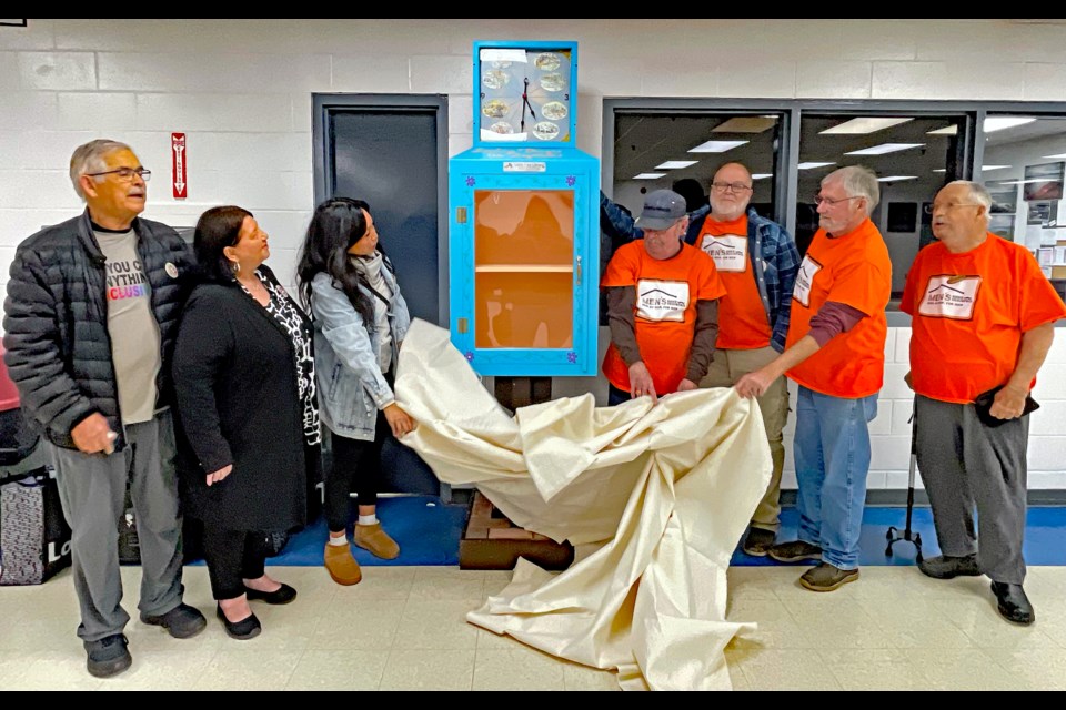 The unveiling of the new Little Free Library project - known as the Welcoming Clock - at the Innisfail Twin Arena on Nov. 21. From left to right are Bill Hoppins, Donna Arnold and Tasha Busch - members of the Innisfail Welcoming and Inclusive Communities Committee, and then Terry Leicht, Robert Charles Silk, Dale Ray and Louis Armstrong from Central Alberta Men’s Shed (Innisfail). Johnnie Bachusky/MVP Staff