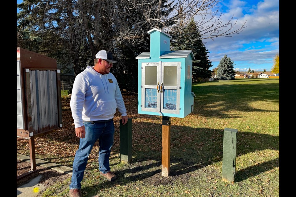 Ryan Dodd, director of grain at Canada Malting Co. Ltd., looks approvingly at the replica of his company's Niobe grain elevator. The replica is a new little free library for Innisfail's Westwood Court neighbourhood. It  was created in partnership by Little Free Library Innisfail and Men's Shed Innisfail. Canada Malting Co. Ltd. sponsored the project. Johnnie Bachusky/MVP Staff