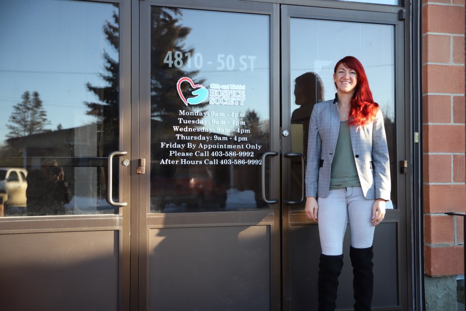 Olds & District Hospice Society (ODHS) executive director Mary Smith stands at the entrance to both the ODHS quarters and the Olds United Church.