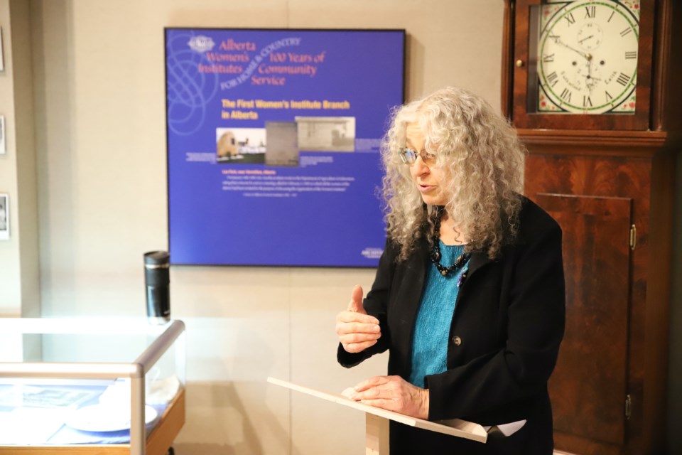 Linda Toews, presidentof the Alberta Women’s Institutes (AWI) and a member of the local AWI chapter in Olds, addresses the crowd attending the AWI exhibit opening.