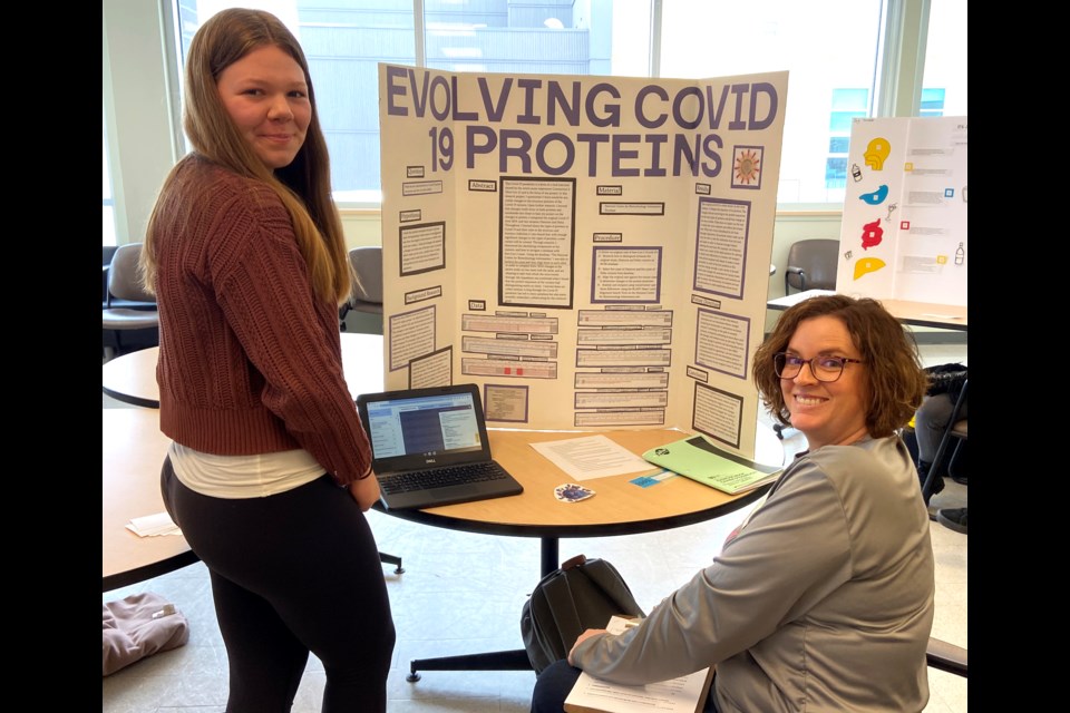 Olds High School Grade 11 student Claire Andrew proudly stands by her project, Evolving COVID-19 Proteins. Andrew received second place and a silver medal for Grades 10 through 12.
