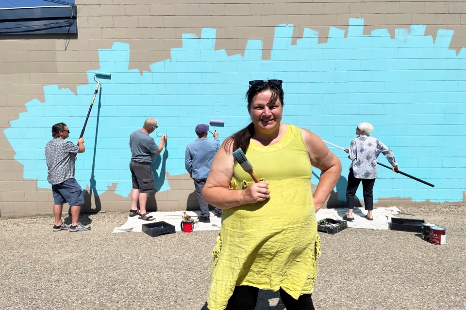 Calgary artist Karen Scarlett and her crew have started their Welcome Mural on the south wall of the downtown heritage building that was once the old creamery. Behind Scarett from left to right is Jason Heistad, Danny Rieberger, Brian Jackson and Alice Jackson. Johnnie Bachusky/MVP Staff