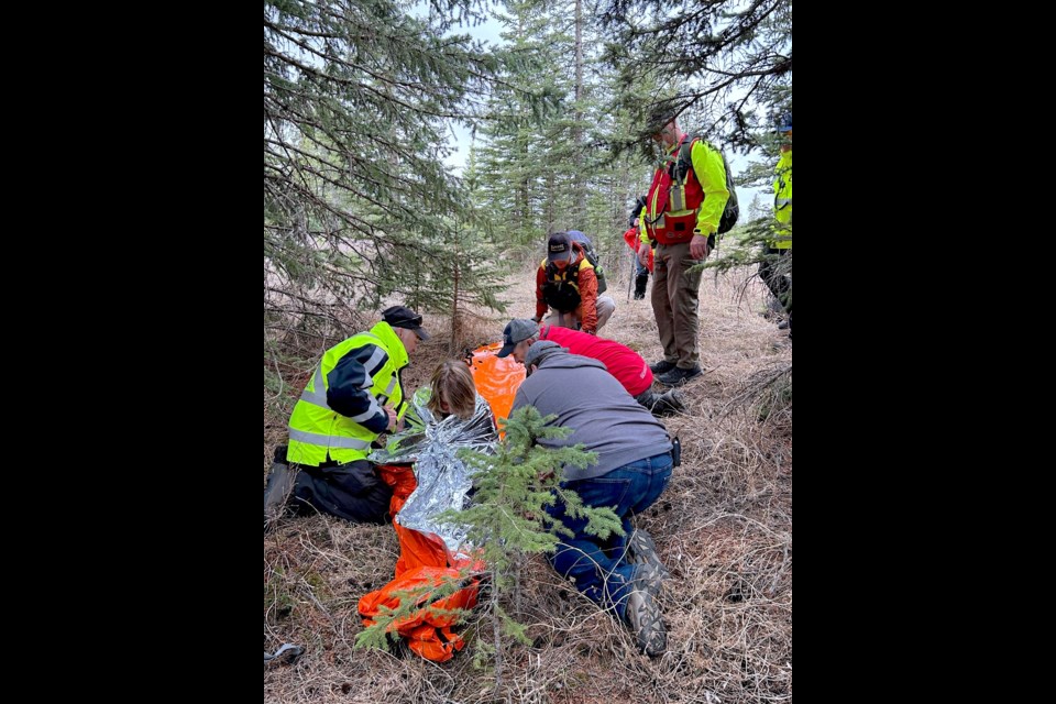 Volunteers stabilize and comfort the "missing" senior after a successful search effort.
Courtesy of Sundre SAR