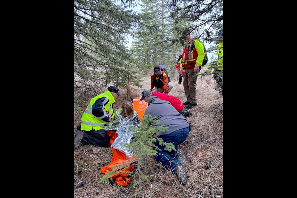 Volunteers stabilize and comfort the "missing" senior after a successful search effort.
Courtesy of Sundre SAR