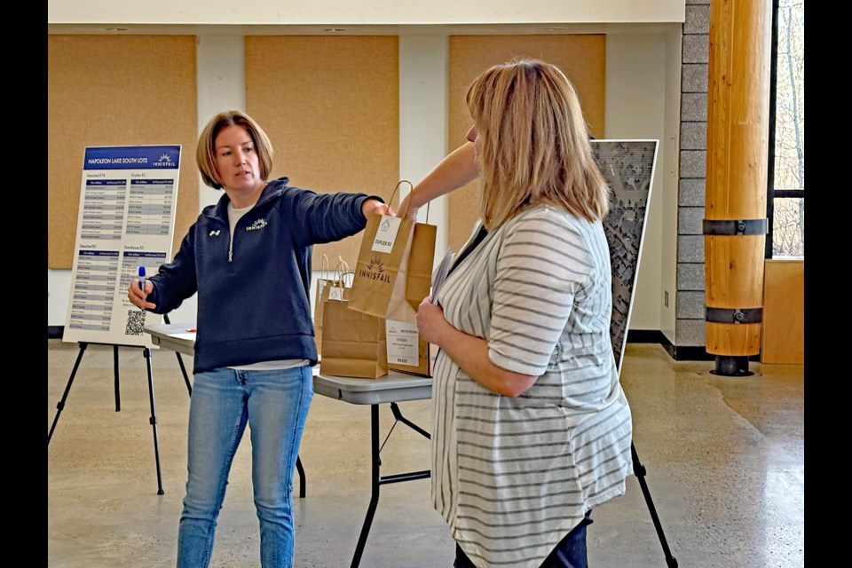 Meghan Jenkins, director of community services for the Town of Innisfail (left), begins the lot draw for the Napoleon Lake South development on April 10 at the Innisfail Library/Learning Centre. Johnnie Bachusky/MVP Staff