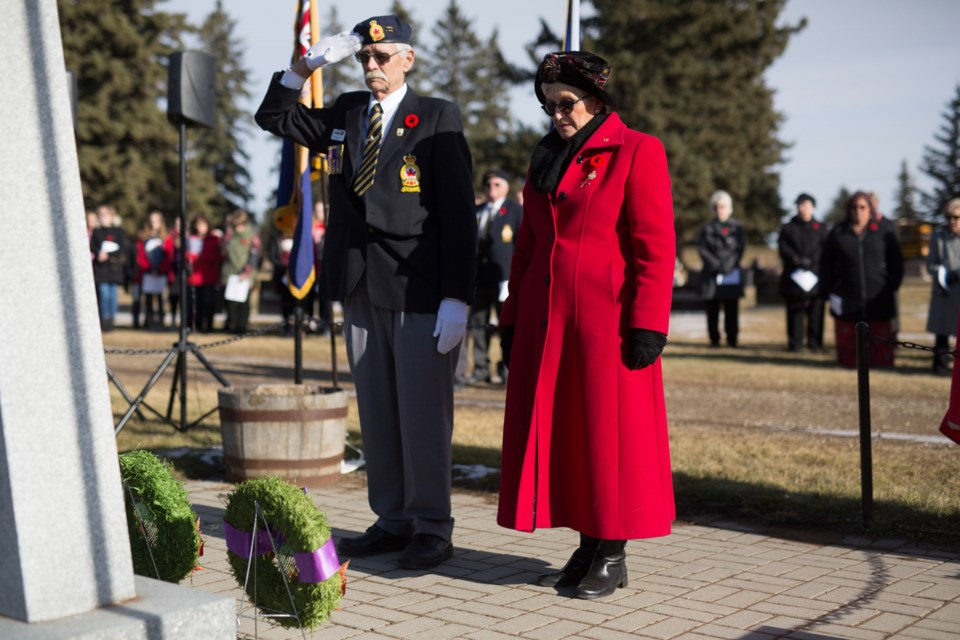 Tom Bartholow, left, and Valerie Braiden lay wreaths at the cenotaph during the ceremony. Noel West/MVP Staff