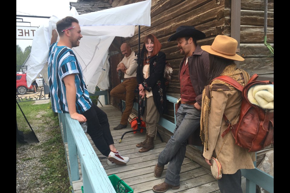 Members of the cast and crew behind an Alberta-based production company called Numera Films, including producer Griffin Cork, left, share a laugh on July 13 at the Sundre & District Museum’s historic pioneer village grounds moments before shooting a scene inside a historic homestead for a horror western flick about three Old West traders who inadvertently end up embroiled in supernatural dealings. 
Simon Ducatel/MVP Staff