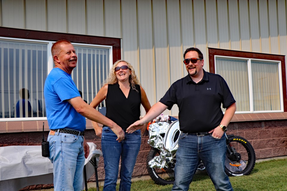 Doug Fenger (left) is congratulated for 50 years of loyal work service at NWP Industries LP by company general manager Shannon Fischer and Jason Steele, president of the energy processing equipment division for Terravest Industries, the parent company of NWP. Johnnie Bachusky/MVP Staff