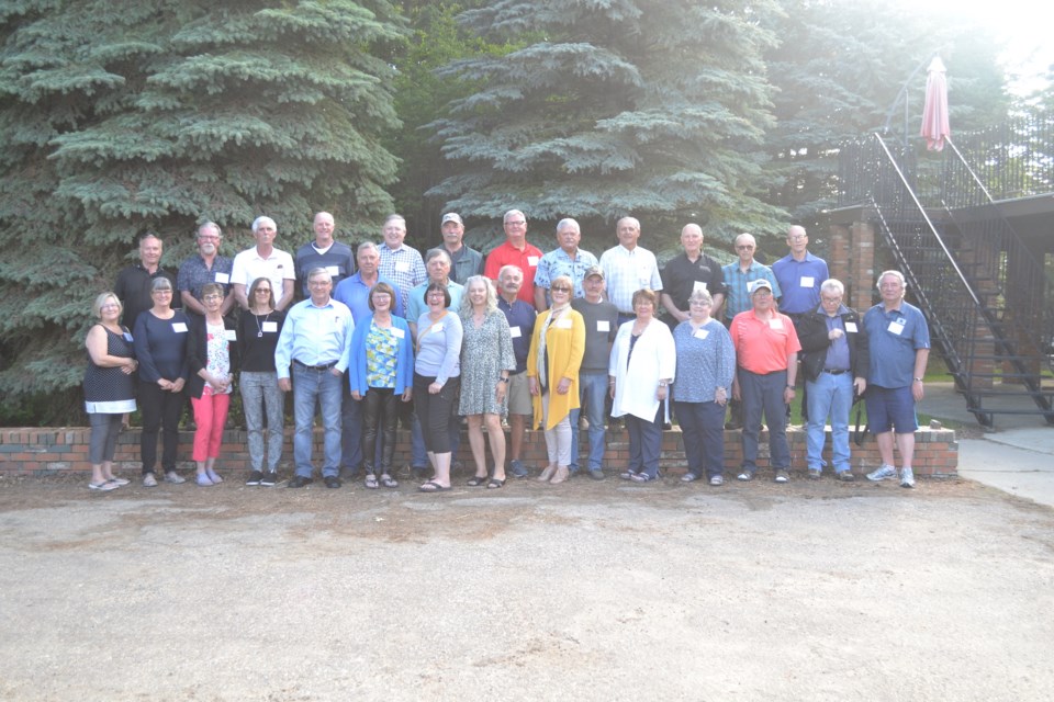 Members of the Olds High School 1972 grad class pose for a photo.