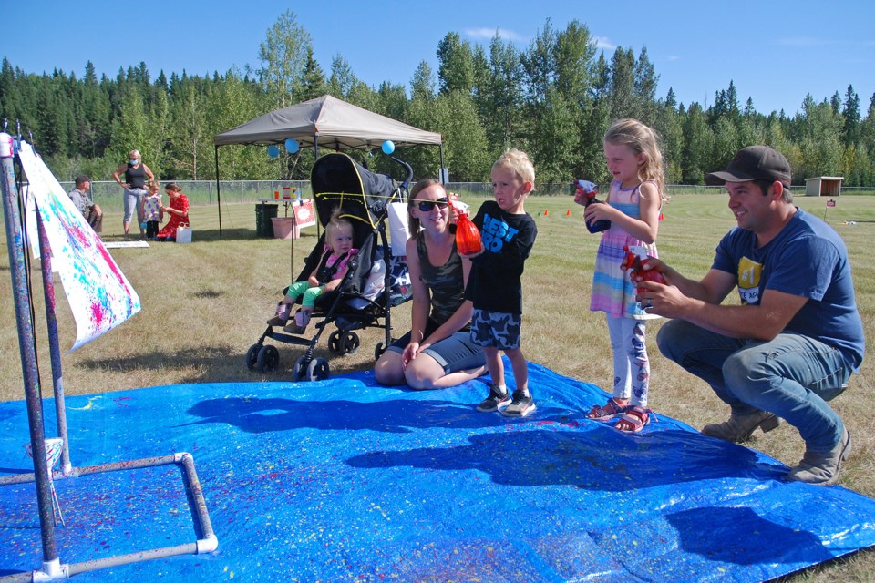 Alexa and Troy Blackhurst, from Sundre, brought out their children Olivia, 1, Chase, 4, and Rebecca 5, to check out the carnival in Sundre. Here, they fire paint-loaded water guns at a canvas to create a colourfully random mosaic.
Simon Ducatel/MVP Staff