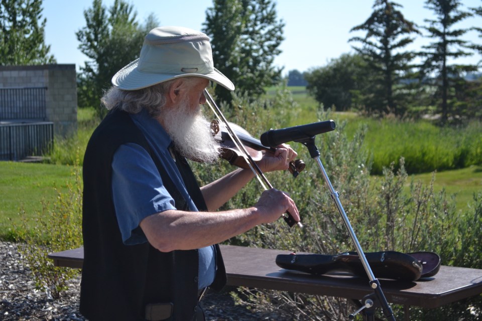 Jim Adamchick provided gentle, soothing music during the butterfly release.