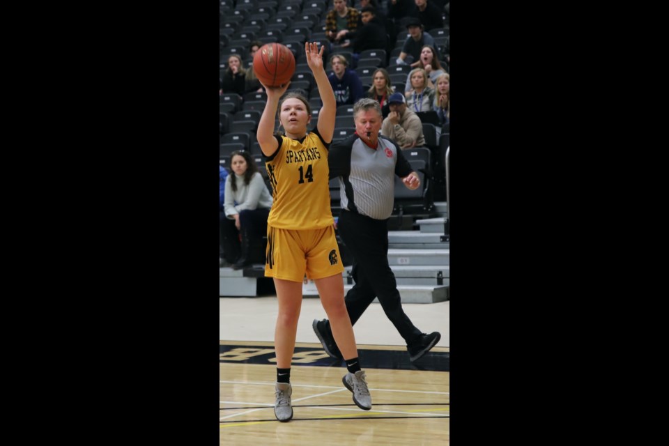 Claire Andrew of the École Olds High School senior girls basketball team goes for a basket during the team’s home tournament Dec. 16.