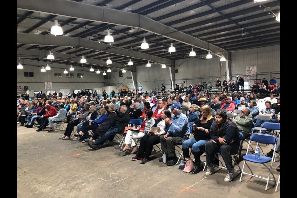 Audience members listen to UCP leadership candidates during the Mountain View Freedom sponsored forum in the Cow Palace in Olds on June 27.