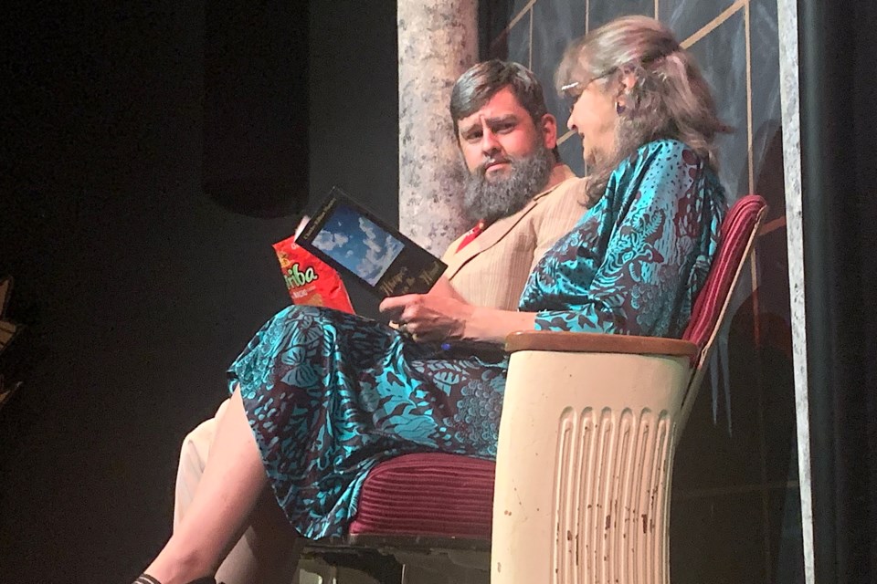 Warren Brisbois made his debut appearance with Peak Theatre Players taking on the role of a theatrically challenged husband named Jack Tisdale who would have much rather been watching the World Series final but wanted to please his wife Ruth Tisdale for the couple’s 25th anniversary. Ruth was played by veteran Peak actor Veronica Embleton, who in this scene tries to calmly explain to a confused Jack why he can’t snack on chips during the play. Simon Ducatel/MVP Staff  