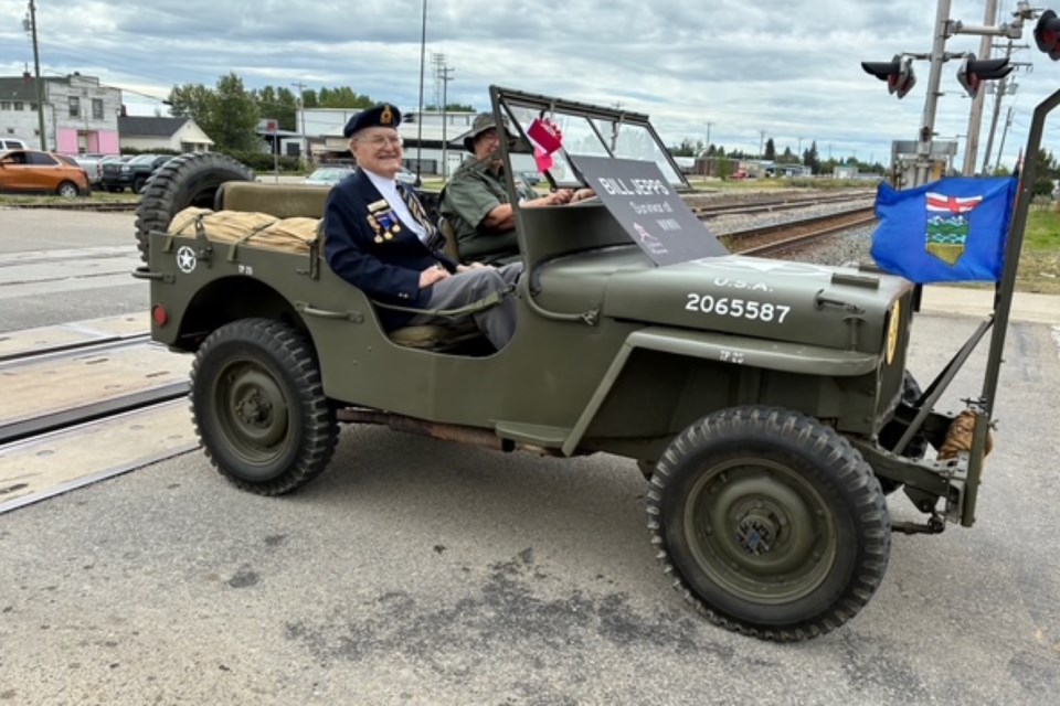 Veteran Bill Jepps rides with Donna Geekie in the vintage jeep earning first place in the antique open category winner.