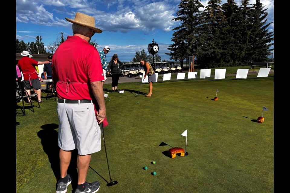 Golfers at the Innisfail Golf Club trying their luck at the Putt for Dough contest on July 3 that was put together by Innisfailians Bill Hoppins and Dex Dersch to raise money to buy hygiene products for the Innisfail & Area Food Bank. Johnniue Bachusky/MVP Staff