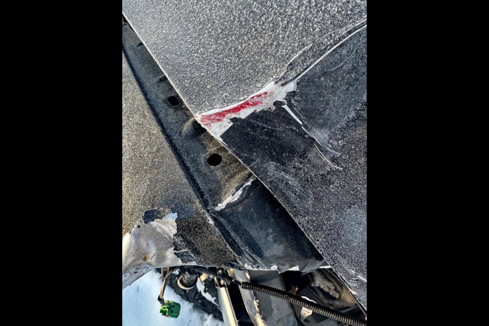 A close-up photo of Sheryl Knock's extensively damaged 2012 Dodge Ram 1500 pickup truck that shows a distinct red paint streak, similar to the colour of the hit and run pickup truck that struck her vehicle on   Highway 2 and then fled the scene. 
Submitted photo