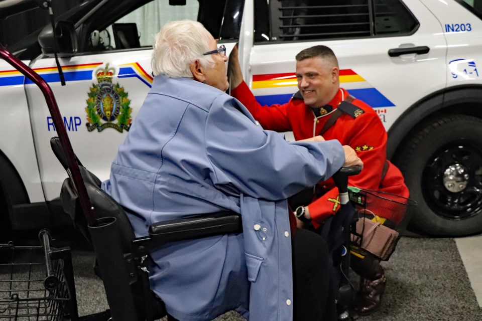 Resplendently attired in his red serge, Innisfail RCMP Const. Craig Nelson is all smiles during a visit and chat from an Innisfailian during last weekend's 2022 Spring Trade Show at the arena. 
Johnnie Bachusky/MVP Staff