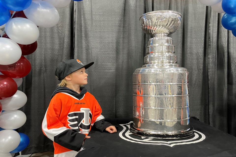 Parks Lattery, an eight-year-old Innisfail U9 hockey player, is awestruck with his in-person look at the Stanley Cup that arrived in town on Aug. 8. The hallowed sports trophy was brought to Innisfail for the day by Ray Bennett, current Colorado Avalanche assistant coach and former Innisfail Eagle. Johnnie Bachusky/MVP Staff