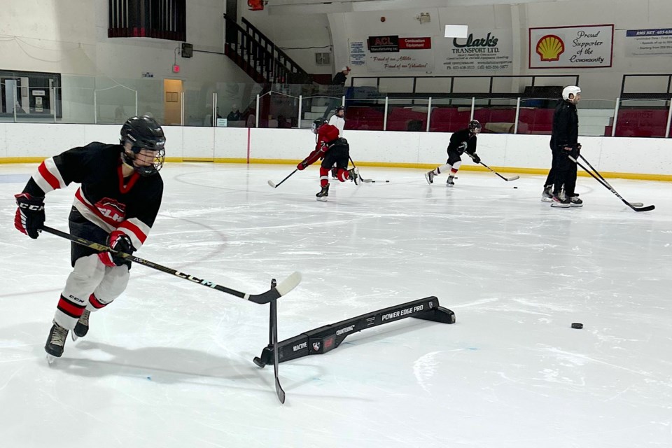 Carson Nault manoeuvres around a specialized piece of equipment as he participates in some drills conducted on Nov. 11-12 during a Power Edge Pro player development program at the Sundre Arena.
Submitted photo