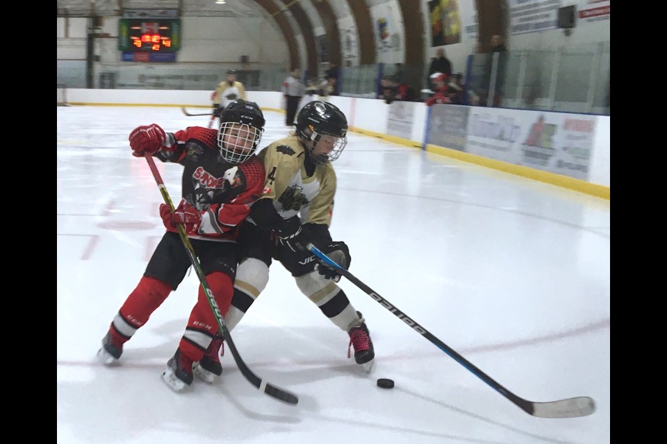 Sundre U13 Huskies assistant captain Ryder Burwell challenges on Saturday, Jan. 21 a player with the Onoway Eagles for control of the puck during the local squad's annual home tournament fundraiser that saw five visiting teams come to town for a hockey-packed weekend.
Simon Ducatel/MVP Staff