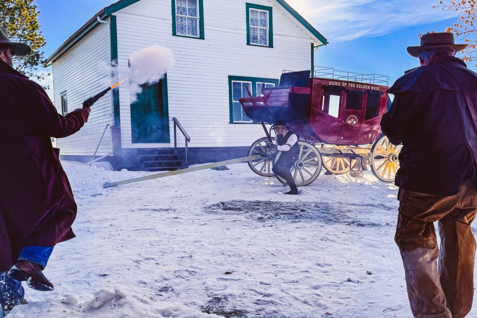 Gun fight at the stagecoach during a performance by the Calgary-based Guns of the Golden West at the second annual Snow & Tumbleweeds winter celebration on Jan. 21 at the Innisfail and District Historical Village. The celebration also included several other activities and attractions, including winter activity demonstrations by the Alberta Sports Hall of Fame. 
Photo by Candice Hughes