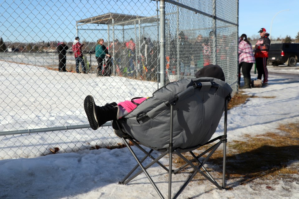 With Feb. 13 being a gorgeous mid-winter day under mostly blue skies, a spectator rests comfortably during a break in the action at the annual Innisfail Sno-Pitch Tournament. Johnnie Bachusky/MVP Staff