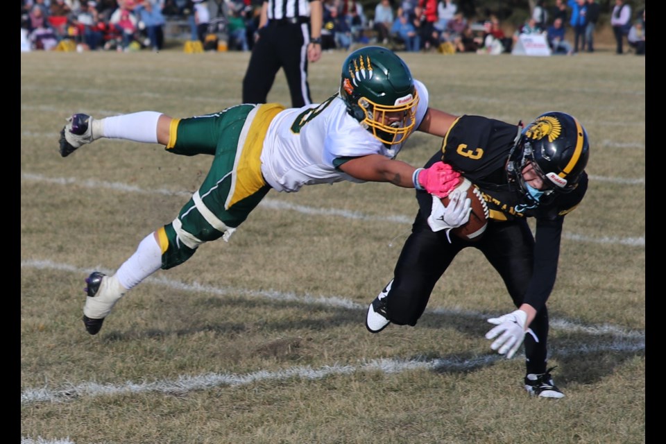 Spartan Ethan Pedersen (3) evades a flying tackle attempt by a Wolverines defender.
Doug Collie/MVP Staff